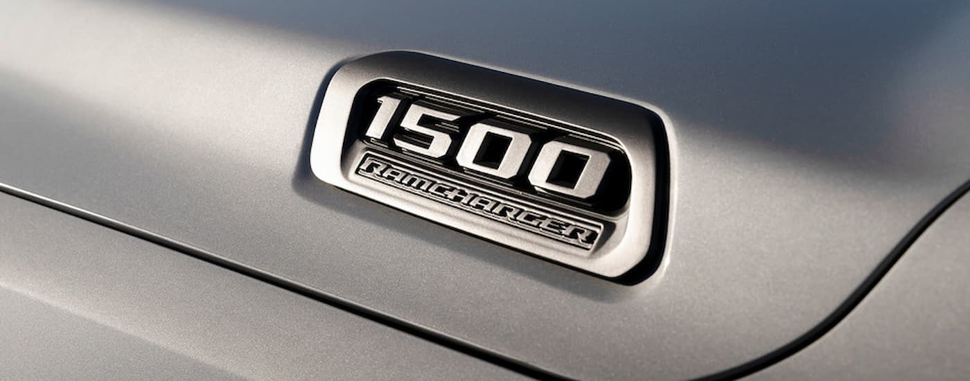 A close up of the badge on a silver 2025 Ramcharger REx is shown.