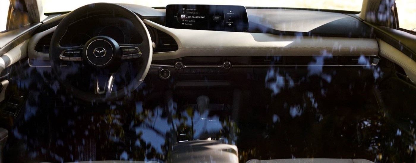 A close up shows the black and grey interior in a 2024 Mazda3.