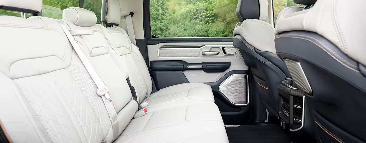 The white rear seats of a 2025 Ram 1500 Tungsten is shown from the passenger side.