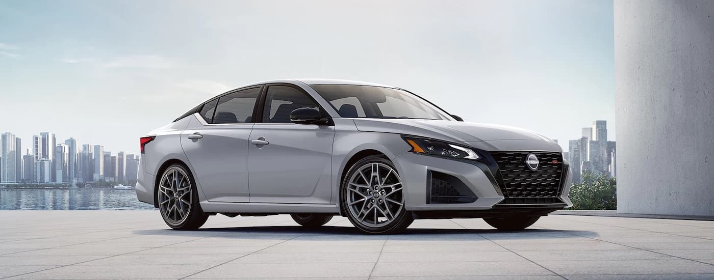 A grey 2024 Nissan Altima SR is shown from the front at an angle after leaving a dealer that has a Nissan Altima for sale.