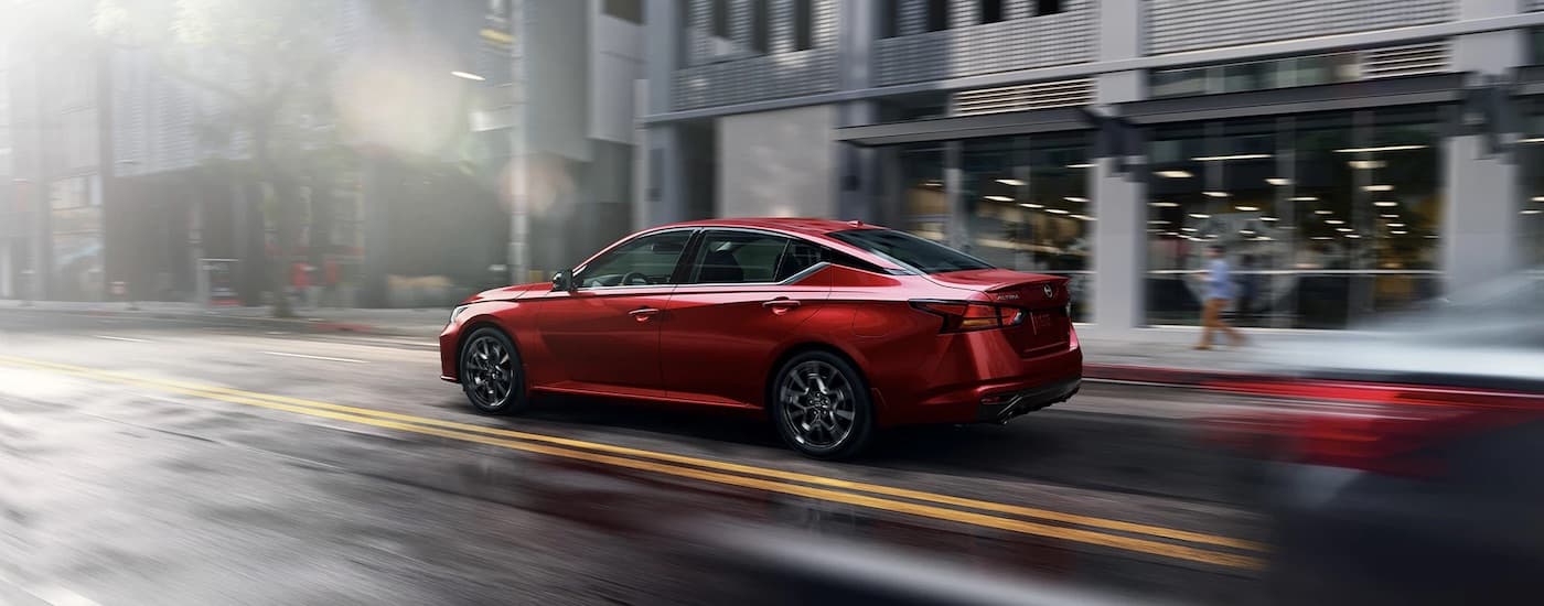 A red 2024 Nissan Altima SR is shown from the rear at an angle.
