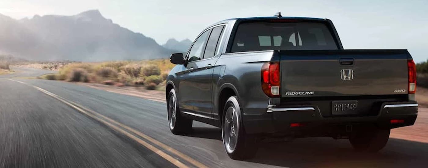 A grey 2020 Honda Ridgeline is shown from the rear at an angle.