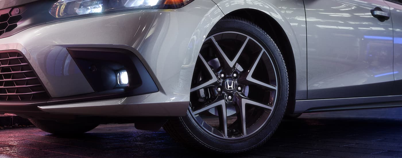 A close up of the tire and rim on a 2024 Honda Civic Hatchback Sport Touring is shown.