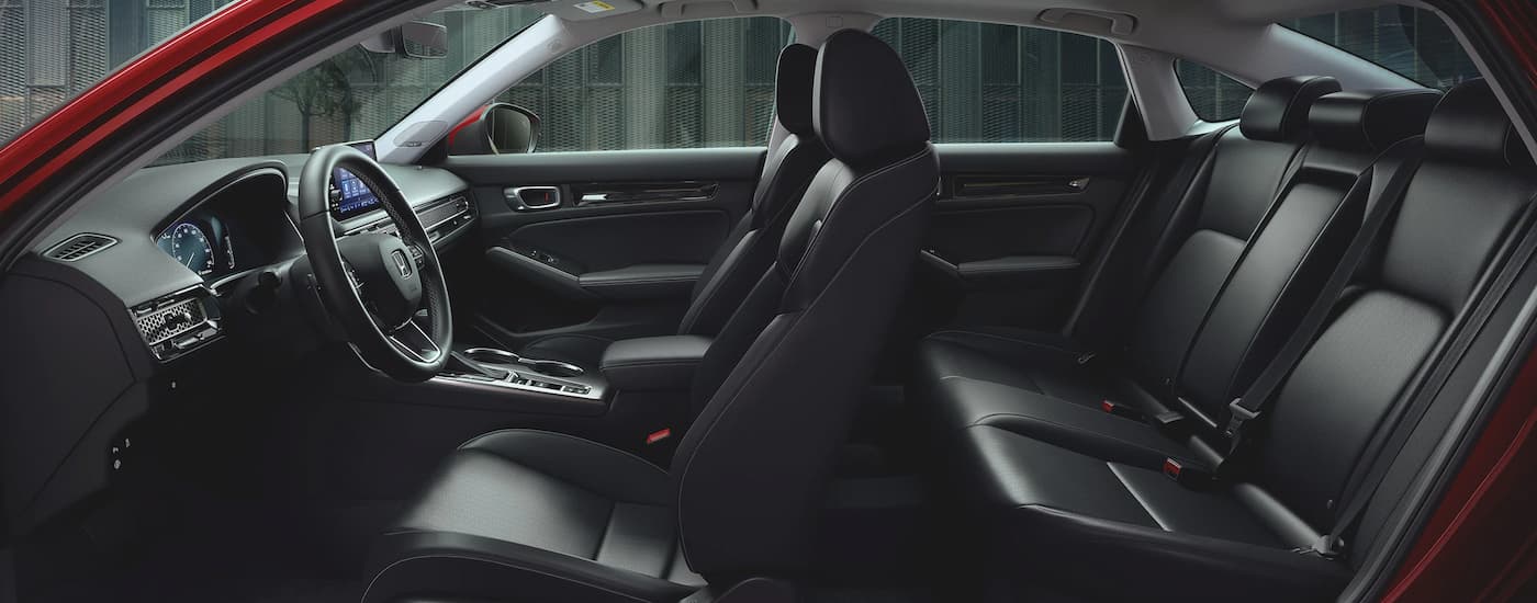 The black interior of a 2023 Honda Civic for sale near Folsom is shown.