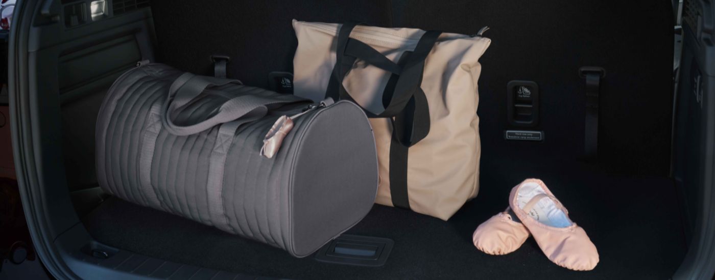 Luggage is shown in the trunk of a 2024 Mazda CX-90.
