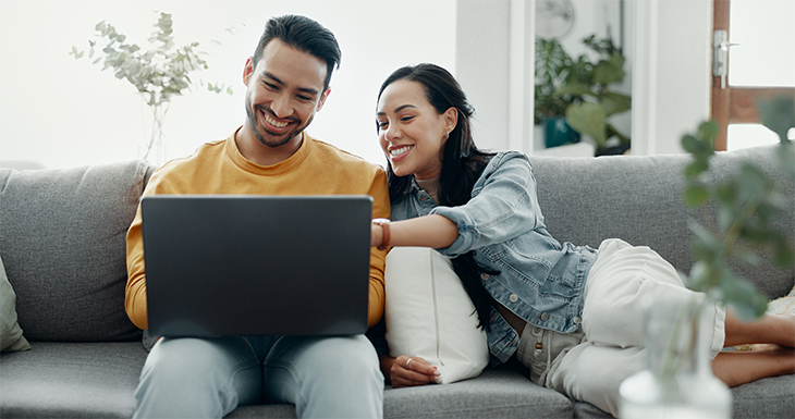 A couple on a laptop selecting a payment