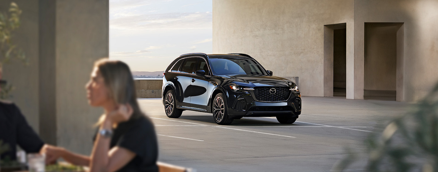 A black 2024 Mazda CX-70 is shown from the front at an angle.