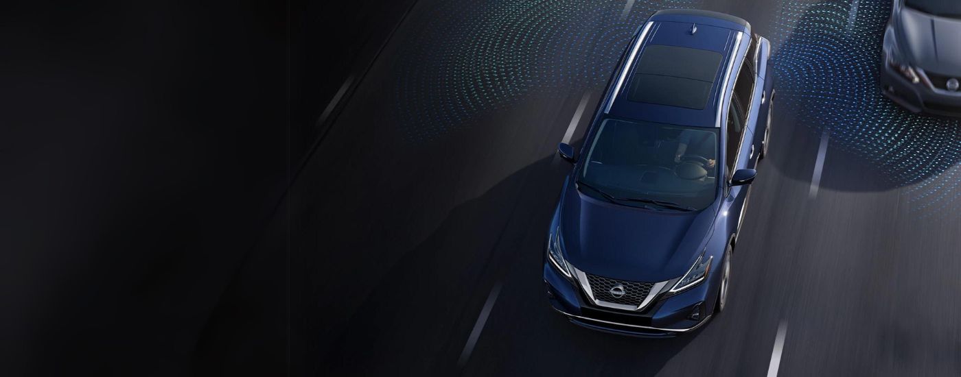A blue 2024 Nissan Murano is shown from a high angle with simulated sensor lines on a highway.