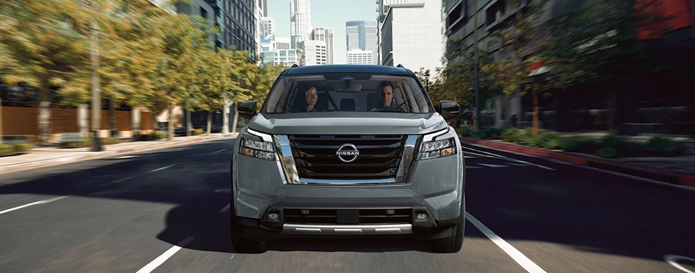 A grey 2024 Nissan Pathfinder is shown from the front.