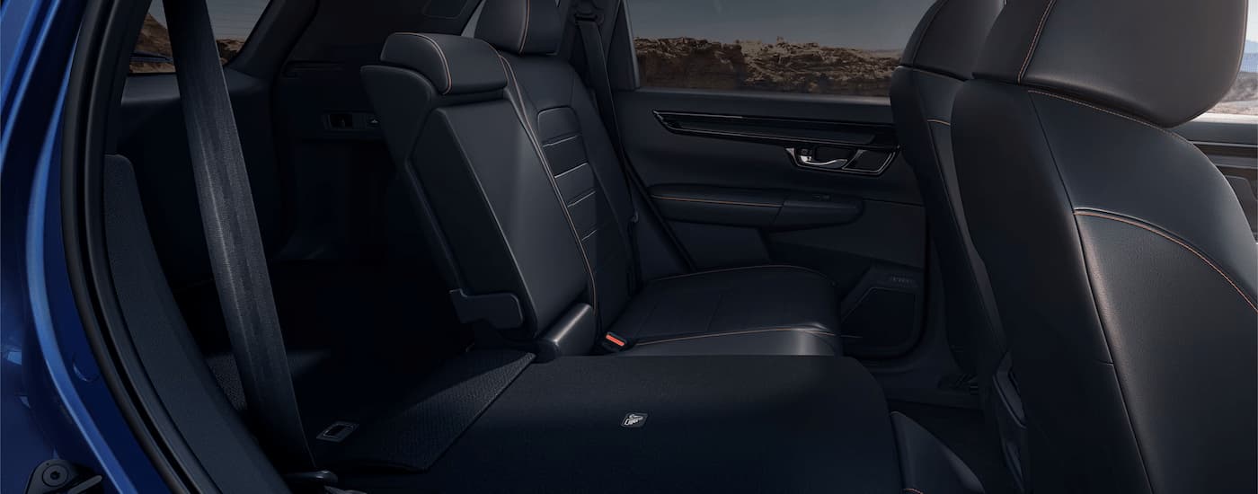 The black interior of a blue 2024 Honda CR-V Hybrid for sale.