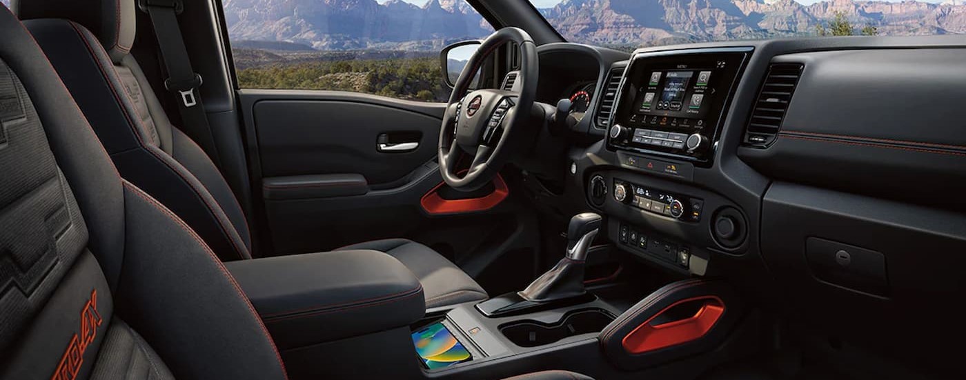 The black interior and dash in a 2024 Nissan Frontier PRO-4X is shown.