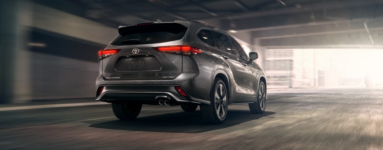 A grey 2021 Toyota Highlander is shown from the rear at an angle.