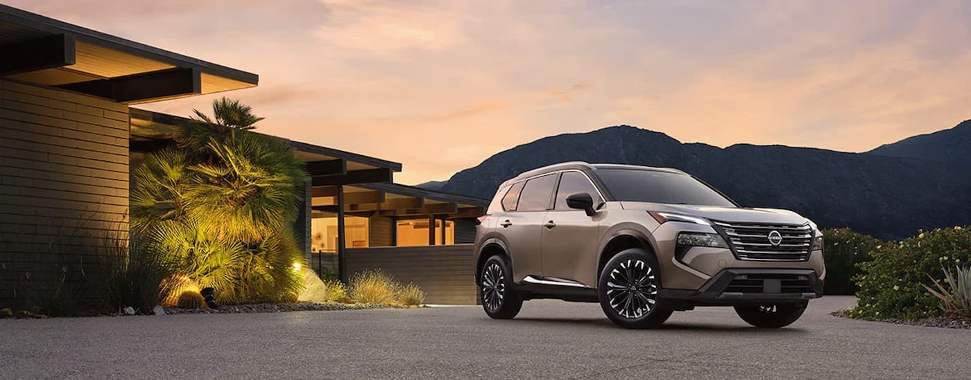 A tan 2024 Nissan Rogue is shown parked after visiting a Nissan dealer near Janesville.