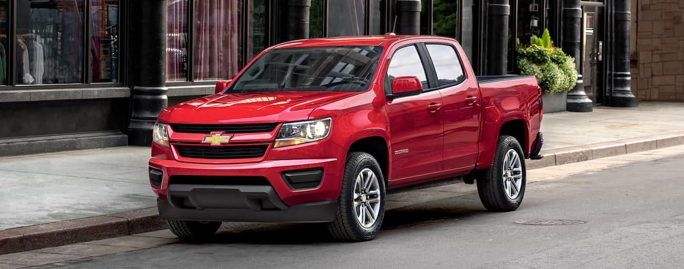 A red 2020 Chevy Colorado is shown parked on a city street.
