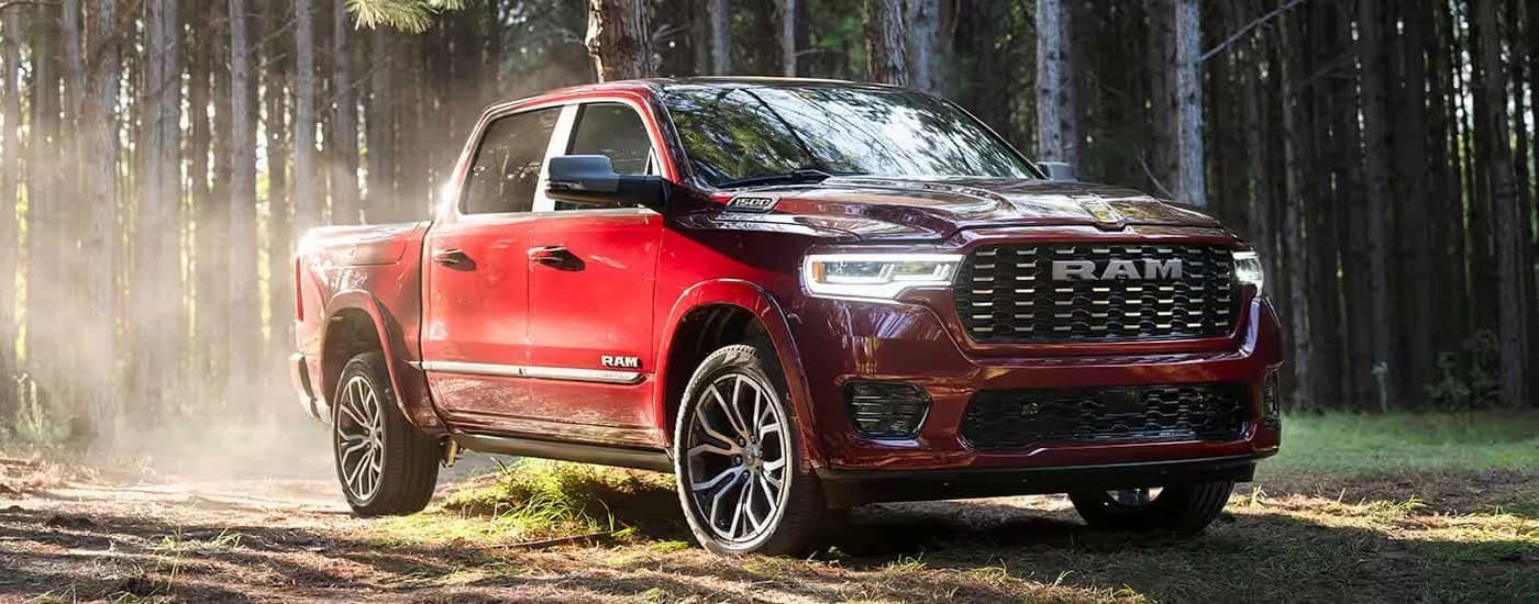 A red 2025 Ram 1500 driving to visit a Ram dealer in Houston.