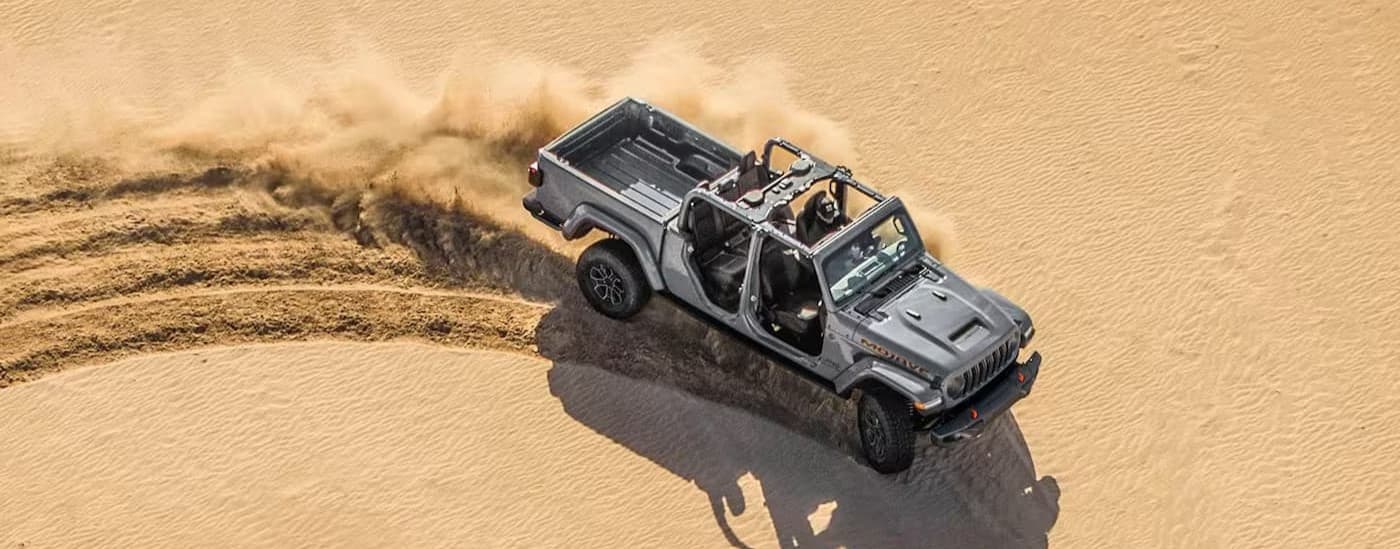 A gray 2024 Jeep Gladiator Mojave driving off-road.