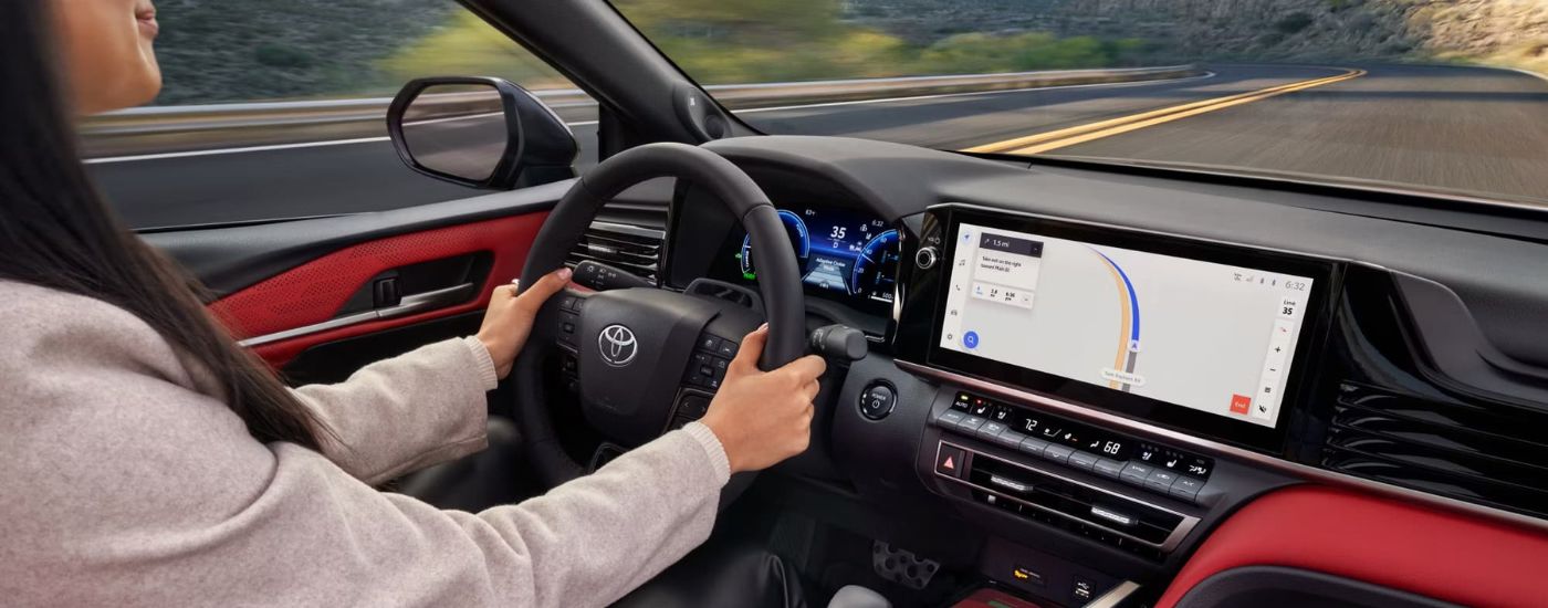 A person steering a 2025 Toyota Camry XSE.