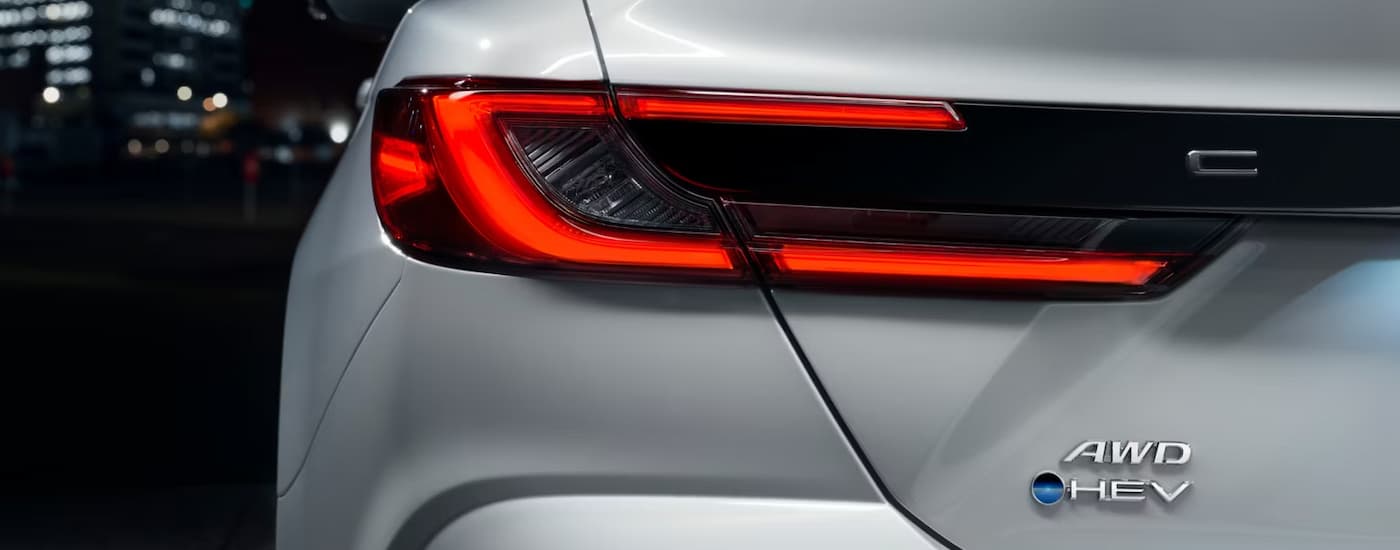 A close up of the rear brakelight of a white 2025 Toyota Camry XSE HEV.