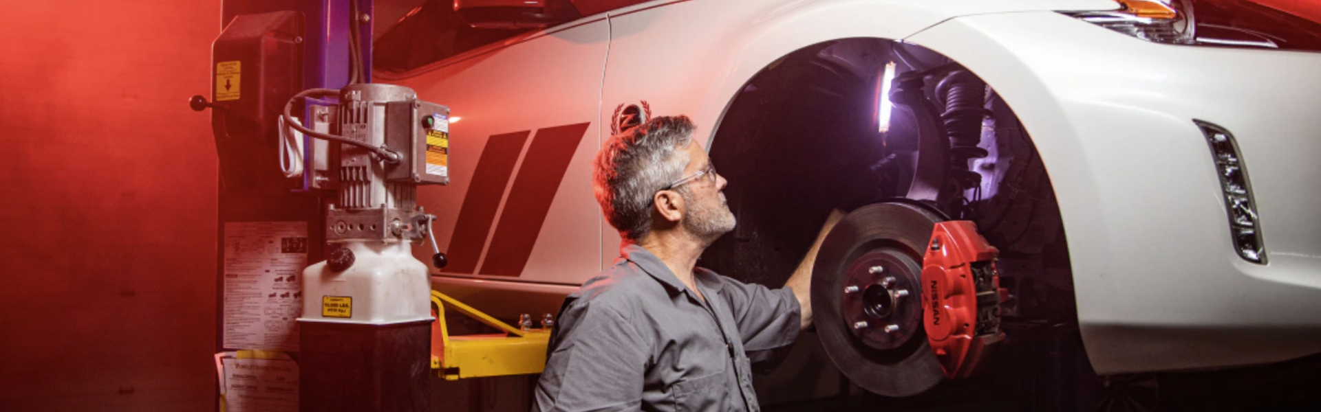 Nissan technician inspecting vehicle