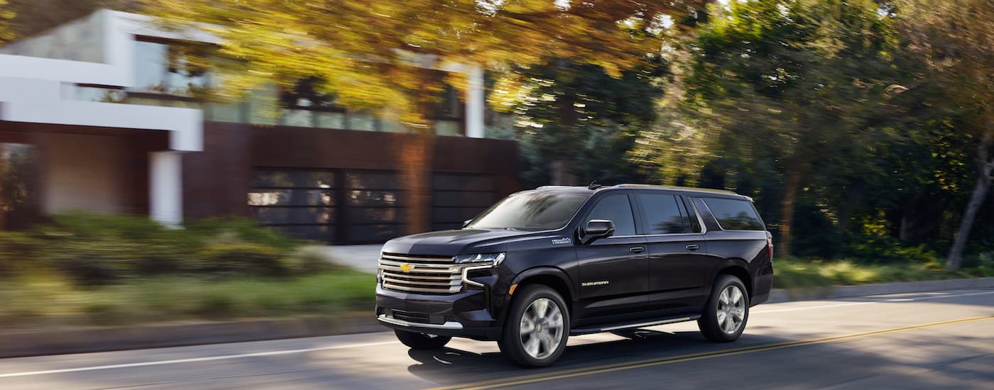A black 2022 Chevy Suburban High Country is shown from the front at an angle.