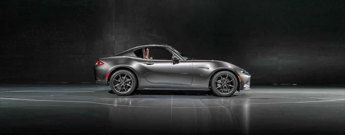 A silver 2023 Mazda MX-5 Miata RF is shown from the side.