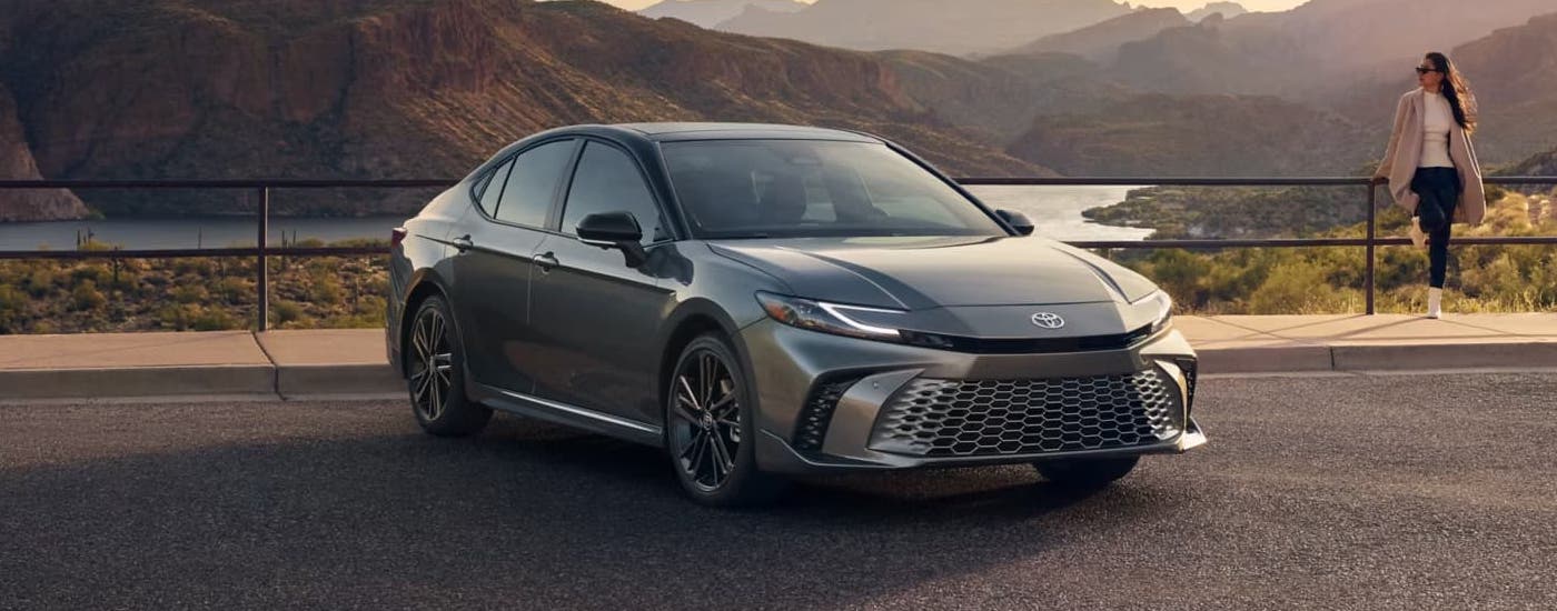 A grey 2025 Toyota Camry XSE is parked overlooking a mountain view.