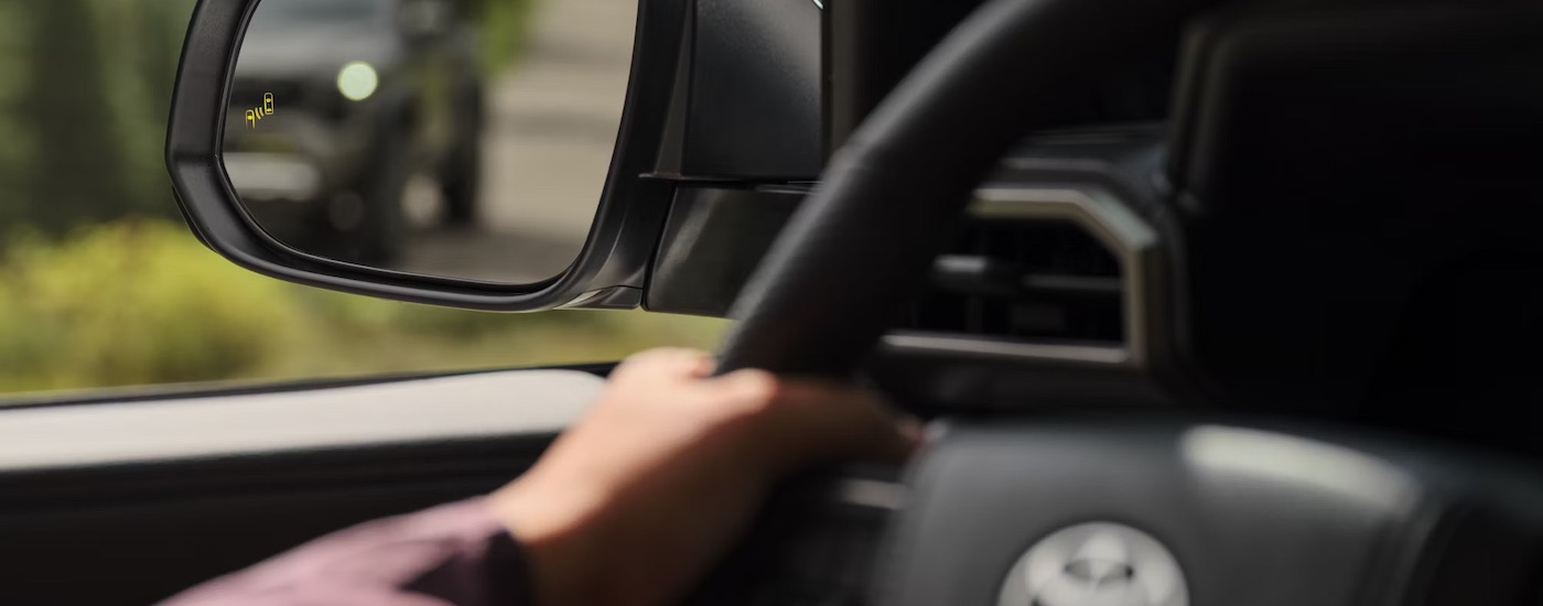 The black interior of a 2024 Toyota Tacoma is shown in close-up.