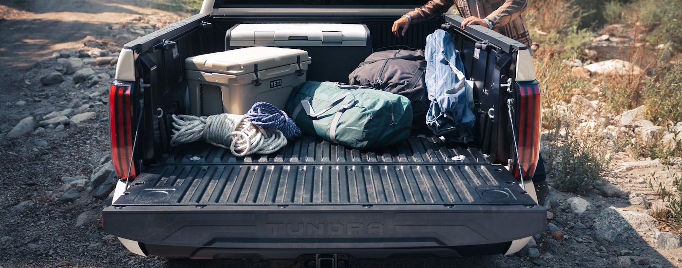 Close-up of gear in the bed of a tan 2024 Toyota Tundra.