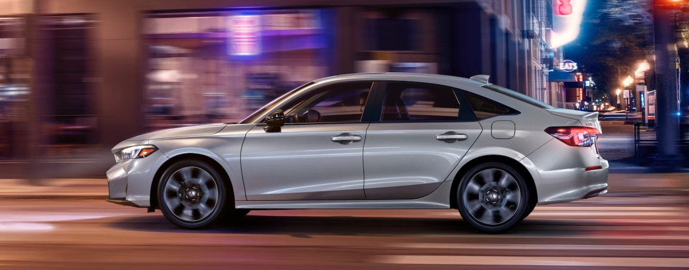 A silver 2024 Honda Civic Hybrid is shown from the side.