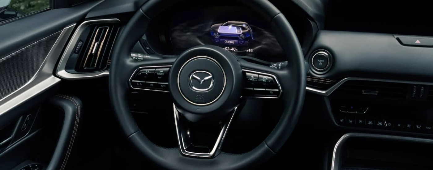 The black leather interior is shown in a 2025 Mazda CX-90 PHEV.