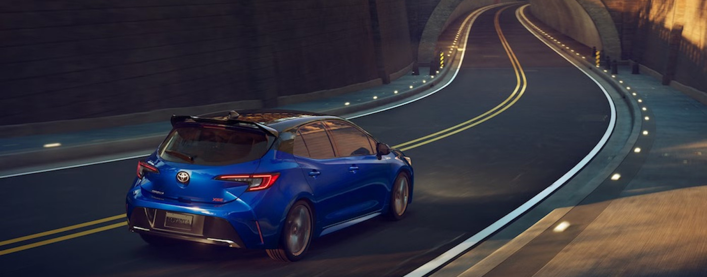 A blue 2023 Toyota Corolla XSE is shown from the rear after leaving a dealer that has a used Toyota for sale.