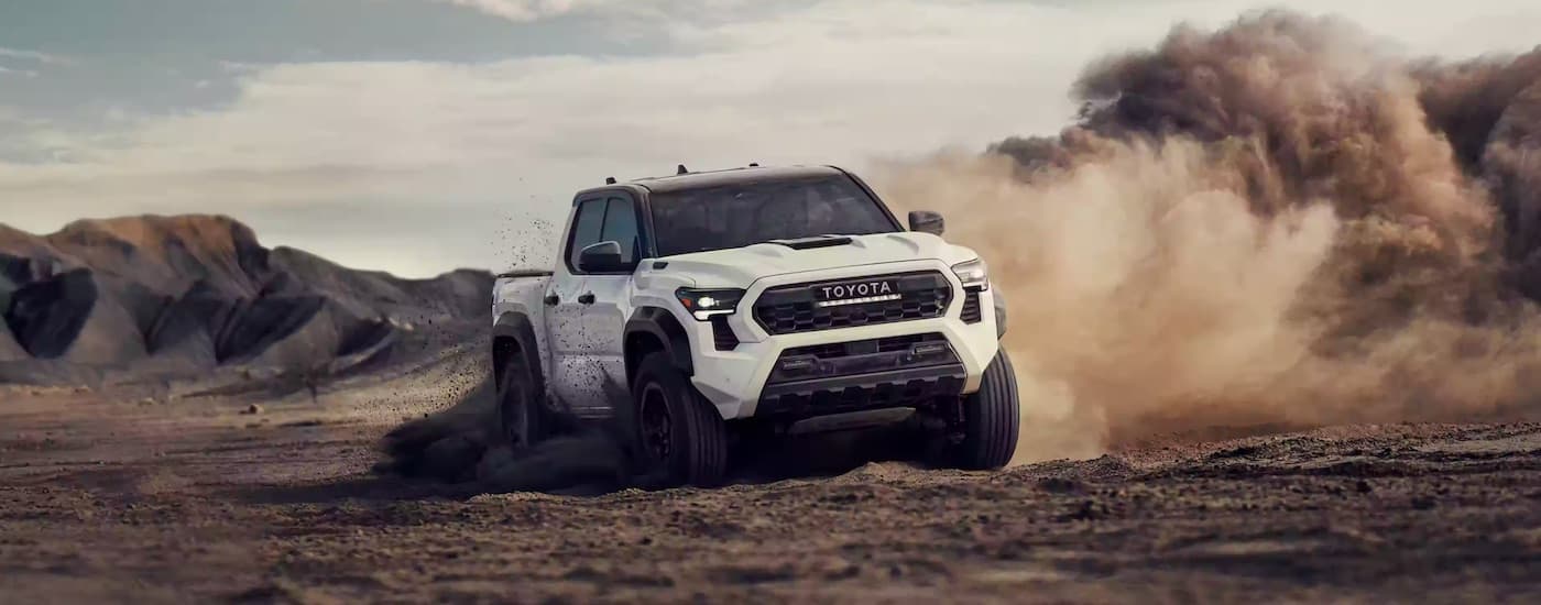 A white 2024 Toyota Tacoma TRD Pro is shown from the front.