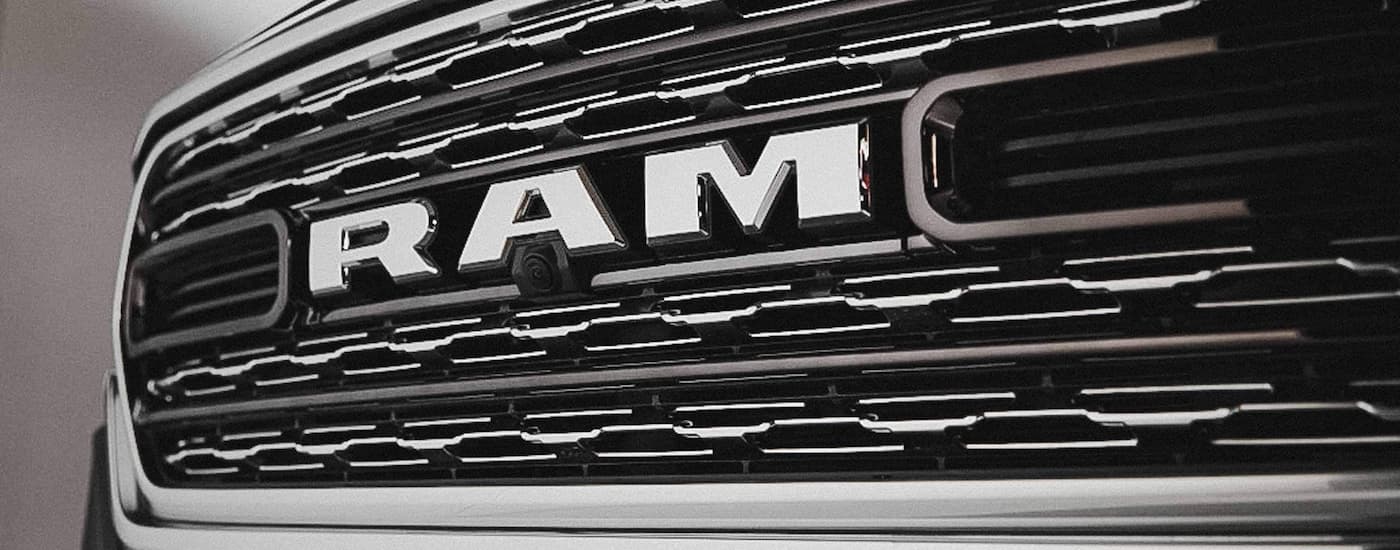 A close up of the grille on a used 2022 Ram 1500 for sale.
