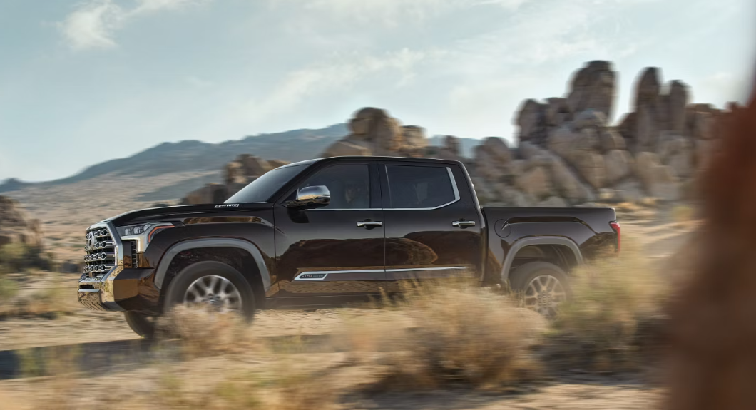 A black 2025 Toyota Tundra driving on a desert road