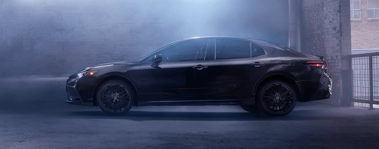 A black 2021 Toyota Camry for sale is shown from the side.