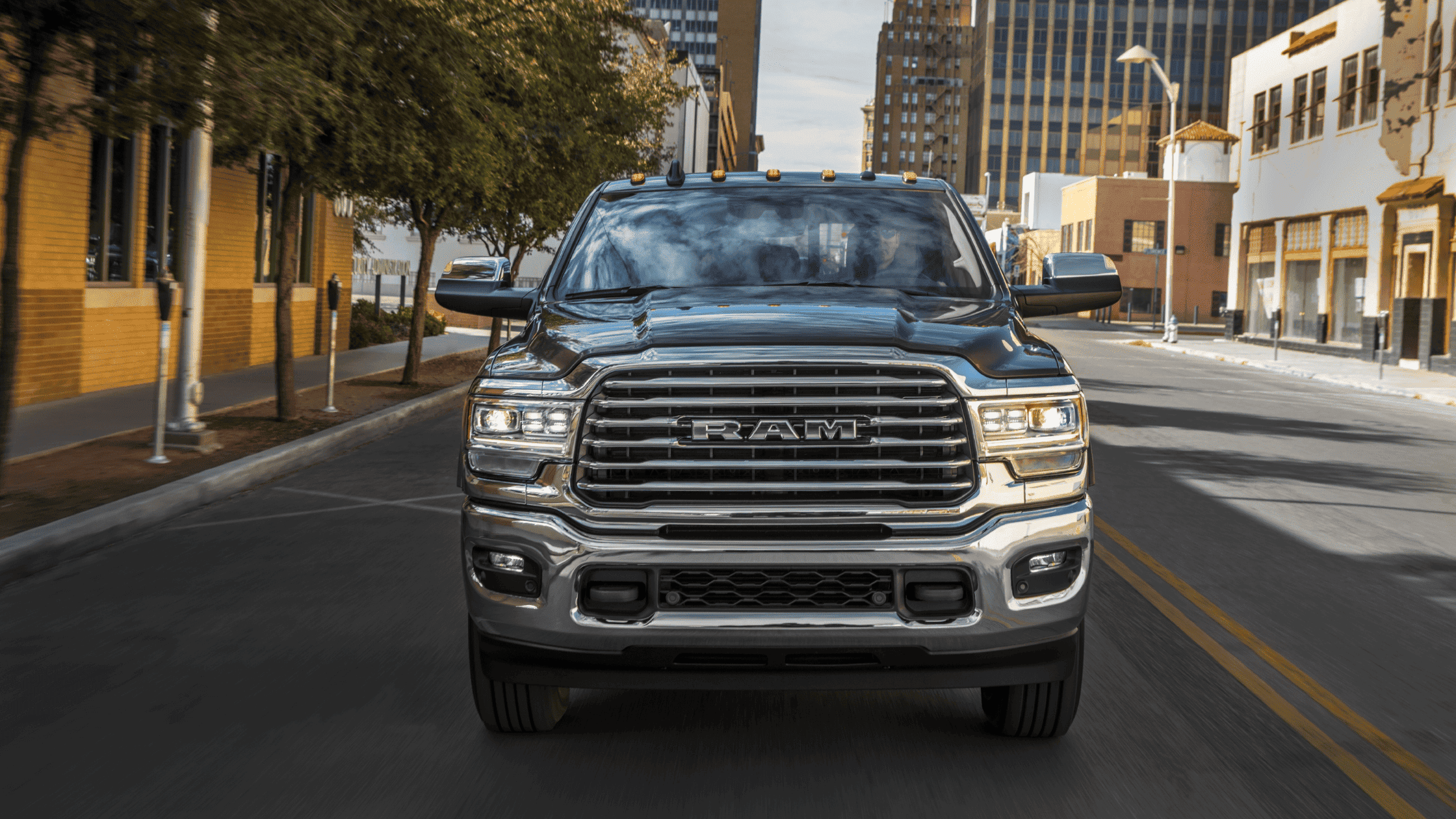 2024 Ram 2500 heavy-duty truck in city setting, showcasing bold front grille.