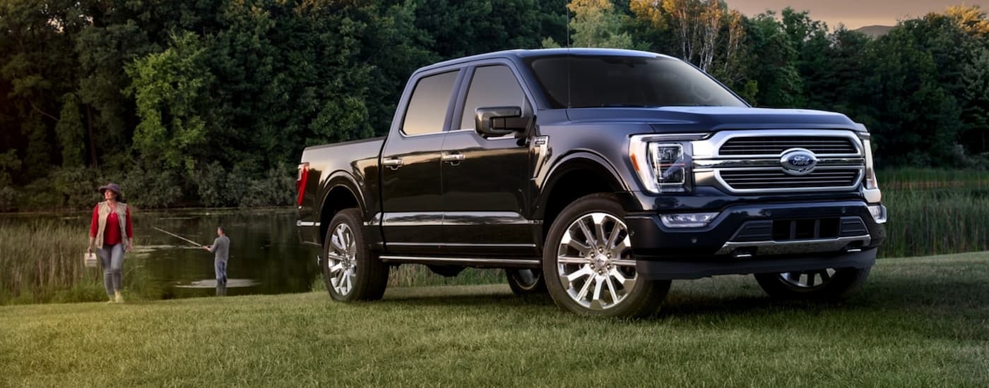 A dark blue 2021 Ford F-150 is shown from the front at an angle.