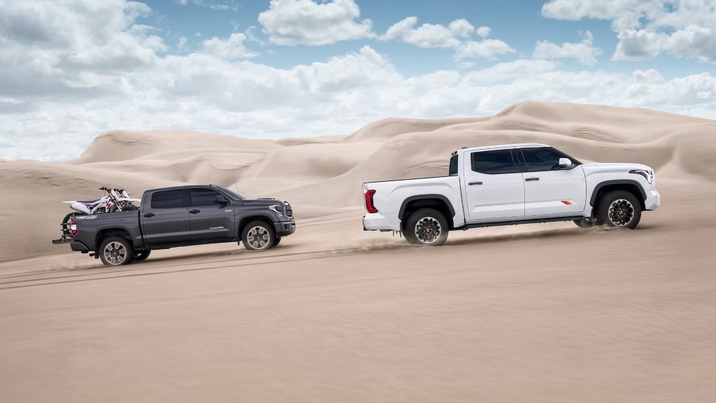 two 2025 Toyota Tundras driving through the desert