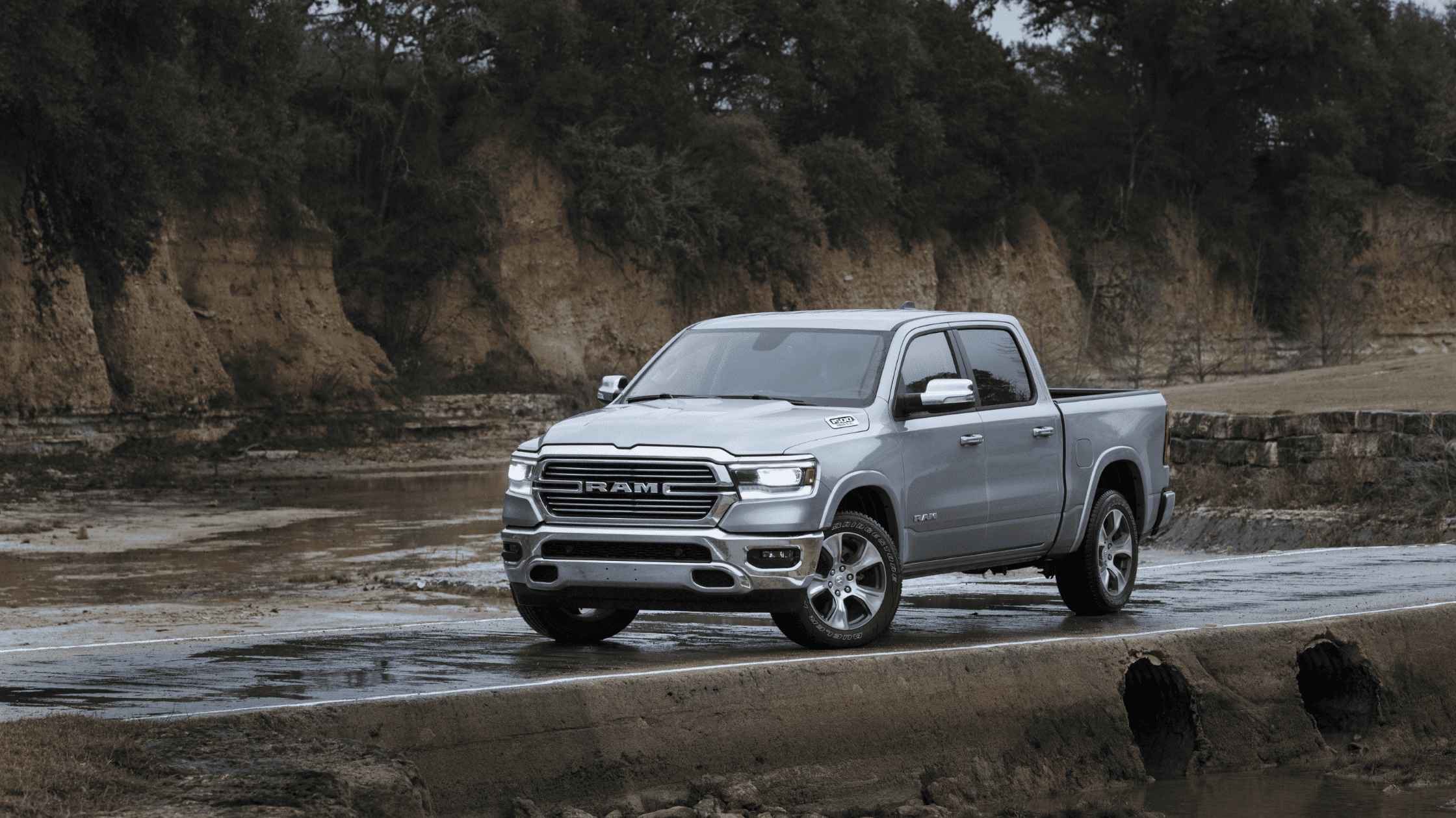 2024 Ram 1500 parked near a rugged landscape, showcasing its durability and sleek design, ideal for Forest City owners looking for reliable performance.