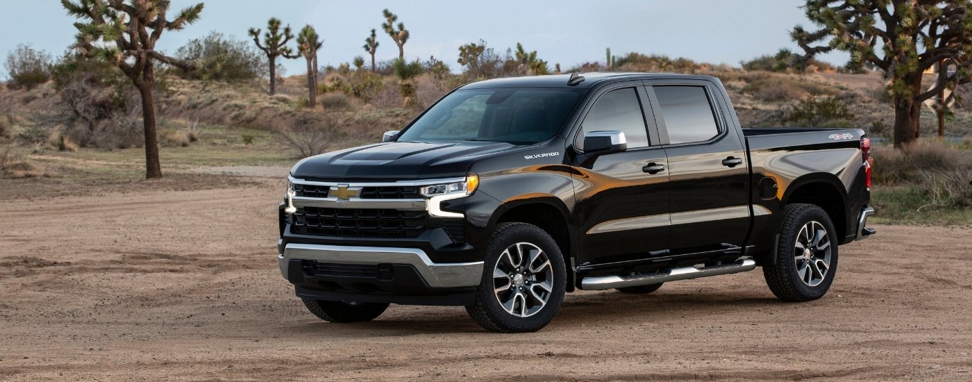 A black 2022 Chevy Silverado 1500 LT is shown off-road.