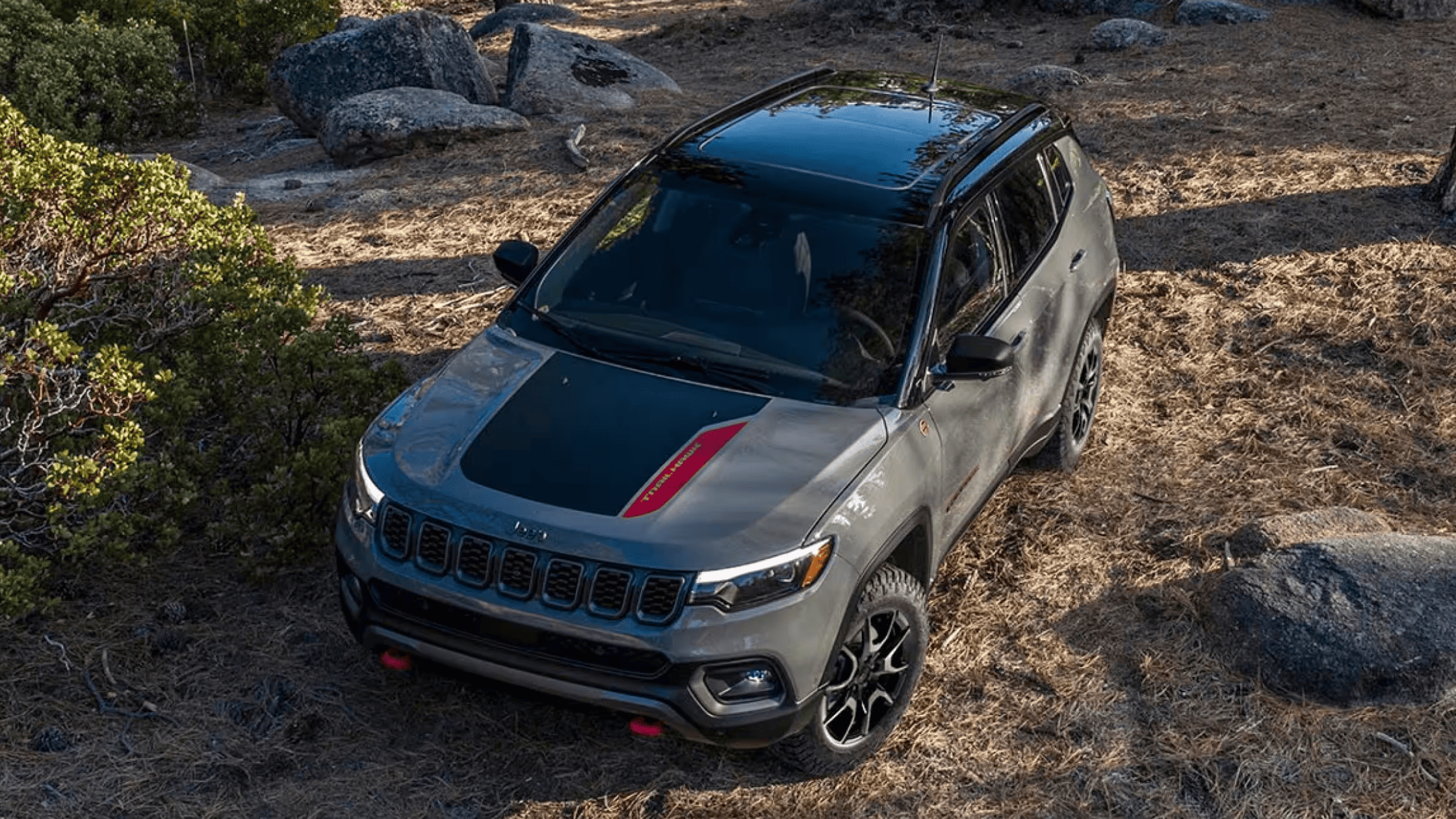 2024 Jeep&reg; Compass parked in a rugged terrain, showcasing its off-road capabilities and stylish design for Forest City, NC adventurers.