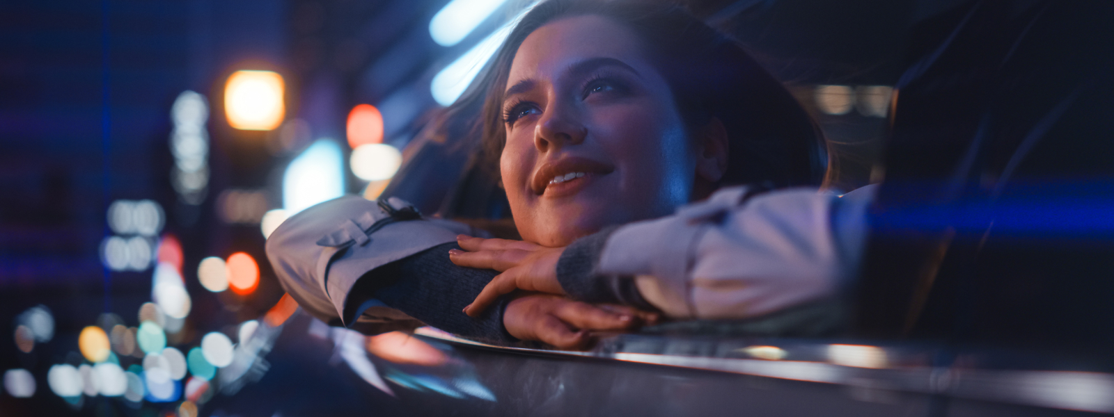 Woman leaning head outside vehicle window