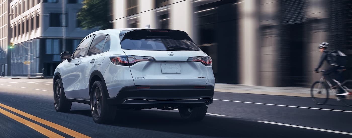 A white 2023 Honda HR-V is shown from the rear at an angle after leaving a dealer that has used cars for sale near Chinle.