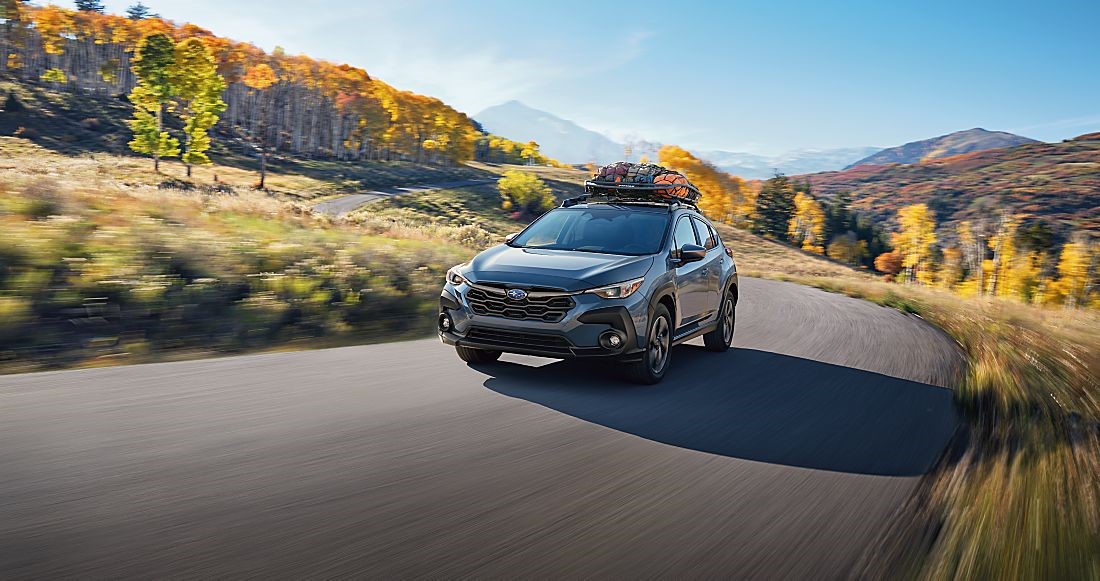 New Subaru Crosstrek driving to a campsite