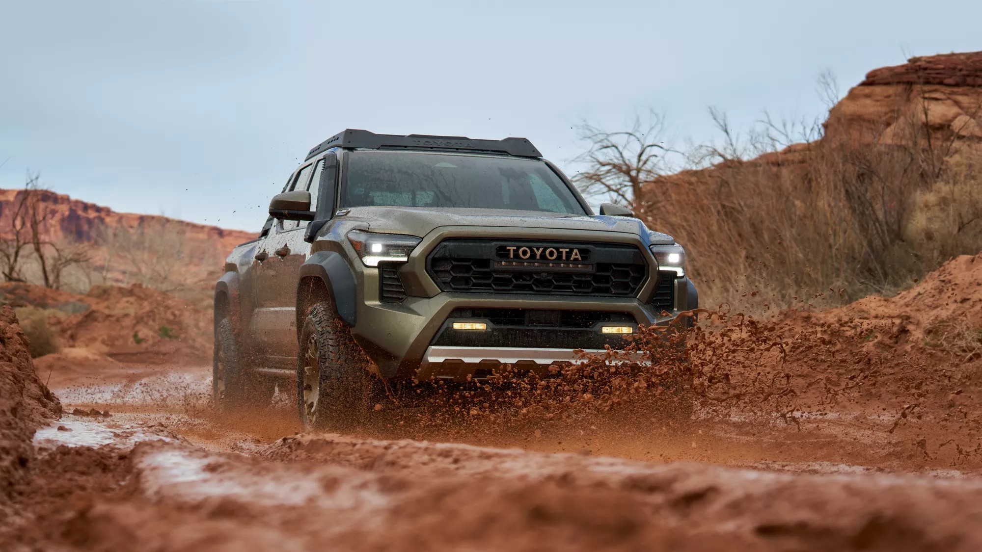 2024 Toyota Tacoma driving on a muddy road