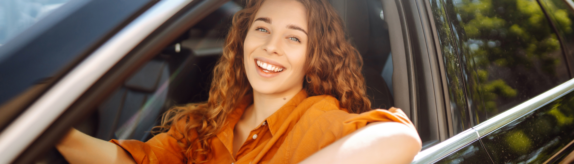 Women smiling outside the window of the driver side window