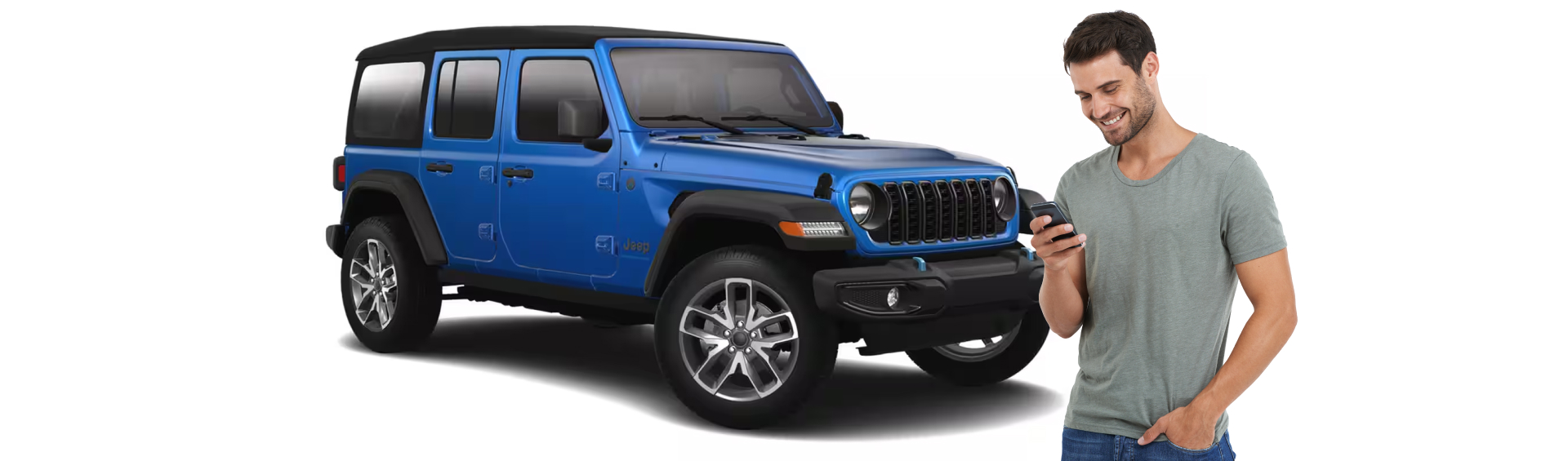 Man looking down at his phone infront of a Blue Jeep