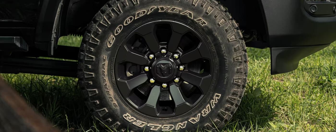 A close up of the muddy tire on a black 2024 Ram 2500.