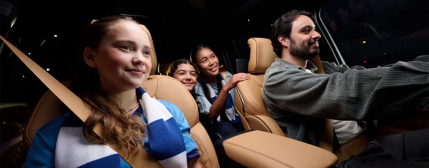 A family is test driving in a 2024 Jeep Grand Cherokee for sale.