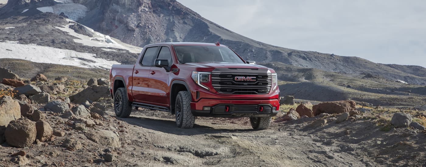 A red 2022 GMC Sierra AT4x is shown from the front at an angle.